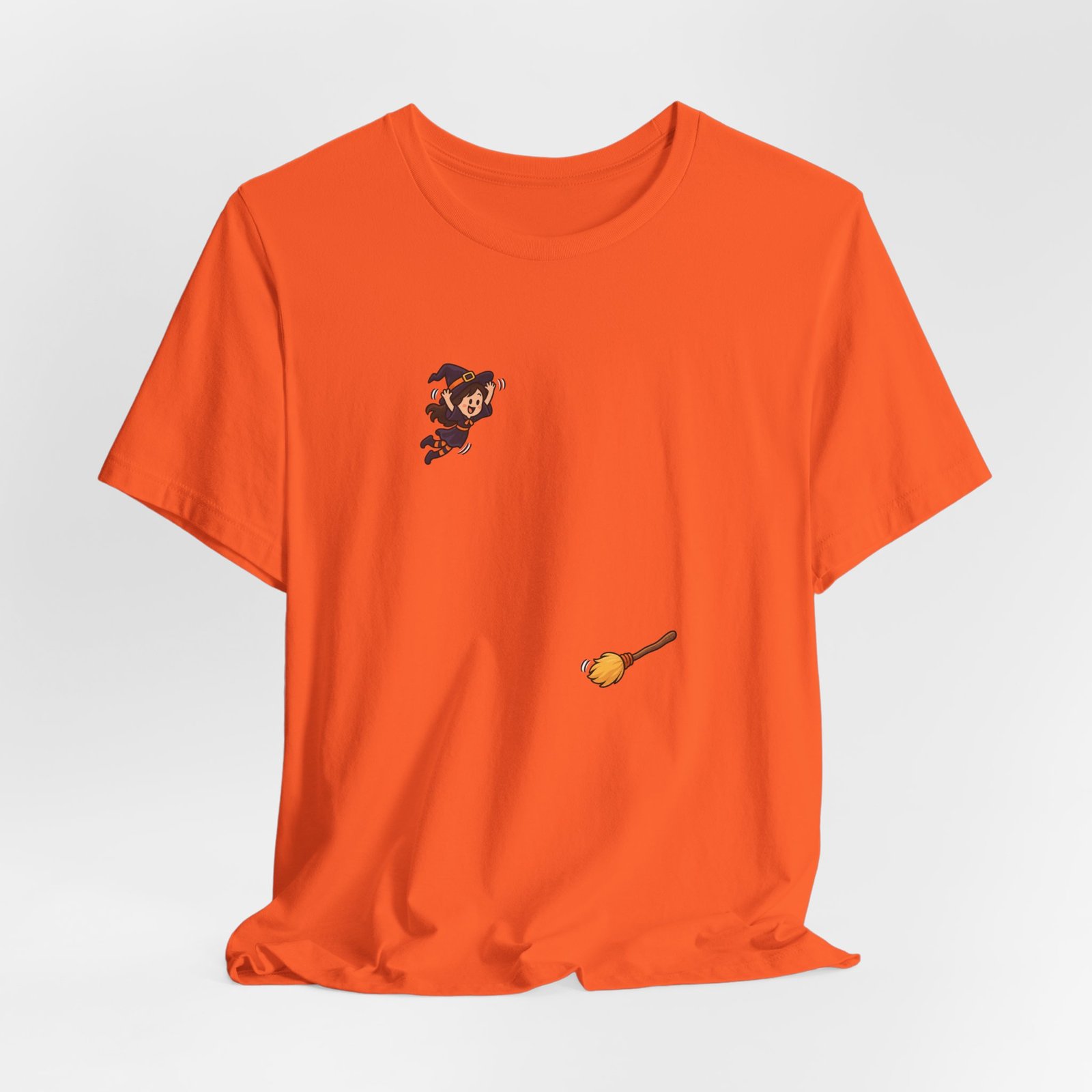 Playful Halloween Witch Jumping Onto Broom Graphic Tee - Image 8